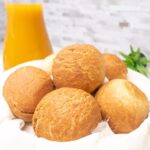a bowl of egg roll and a glass of orange juice