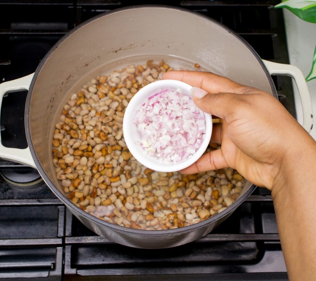 Adding onions to the beans